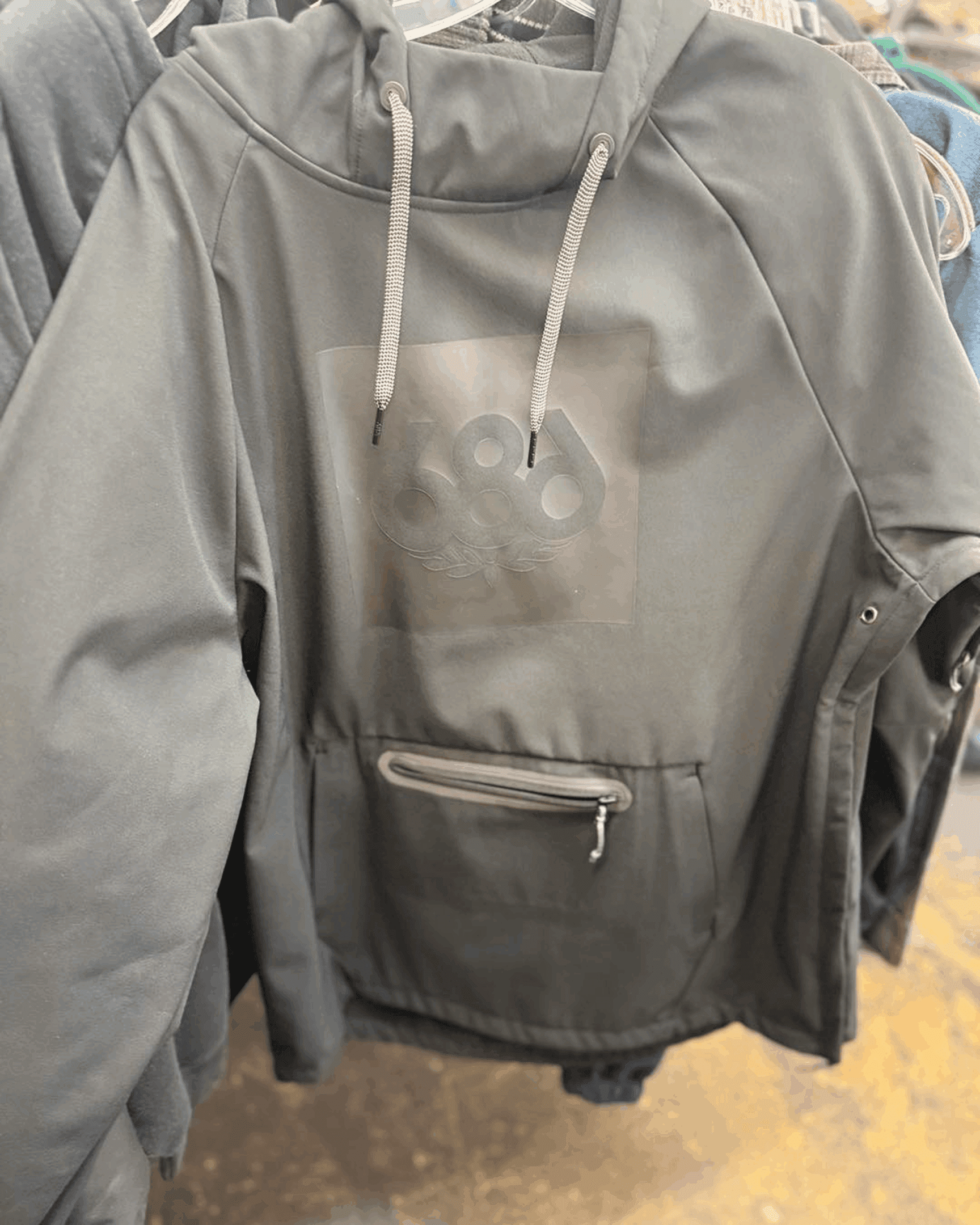 Dark hoodie on clothing rack