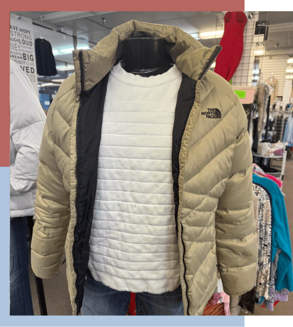 Mannequin wearing tan puffer coat